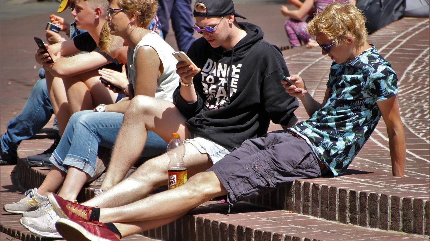 young people on their smart phones being tracked