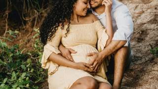 pregnant wife and husband smiling