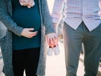 couple with wife pregnant holding hands